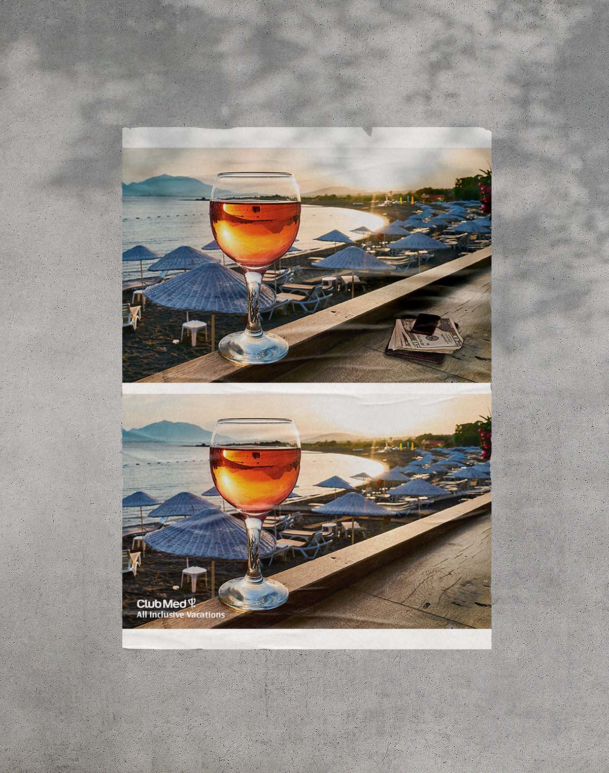 A poster pasted on the wall. The poster has two panels.
            The first panel is an amber drink with an island paradise in the background. A wallet sits on the table beside the drink.
            The second panel is the same as the first, except the wallet is missing.